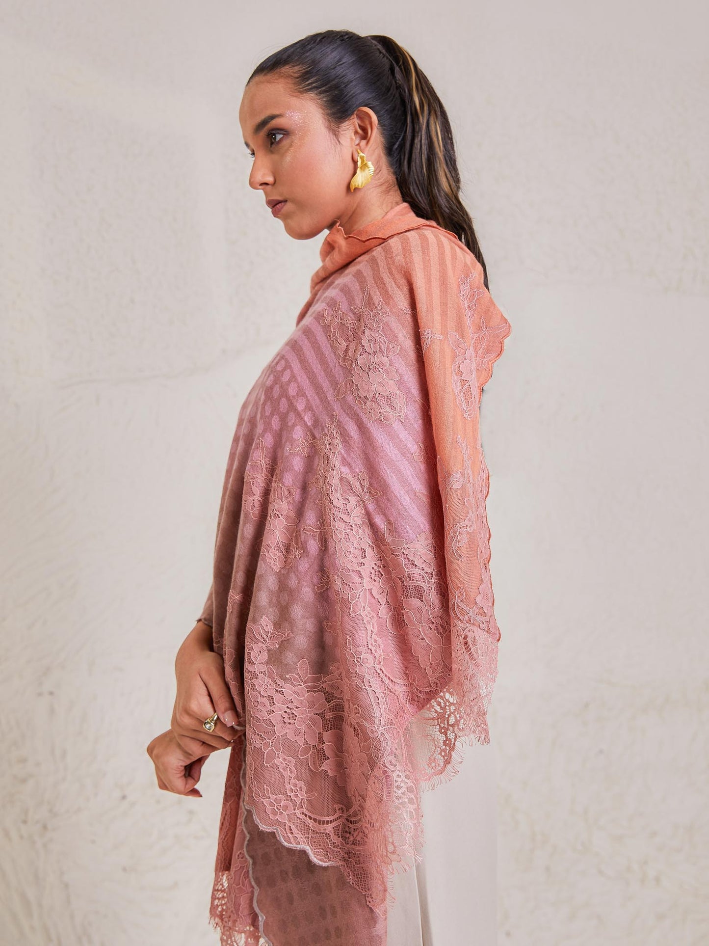 Model is wearing the Celestial Chantilly Pashmina Stole from shaza in baby pink and peach.