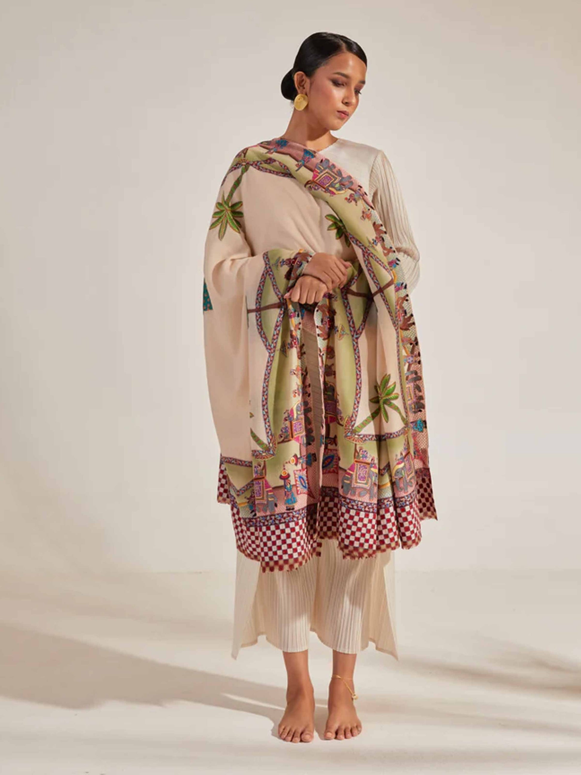 Model is wearing the Var Yatra Pashmina Kalamkari Shawl from Shaza, depicting a baraat procession as the border on a handloomed pashmina.