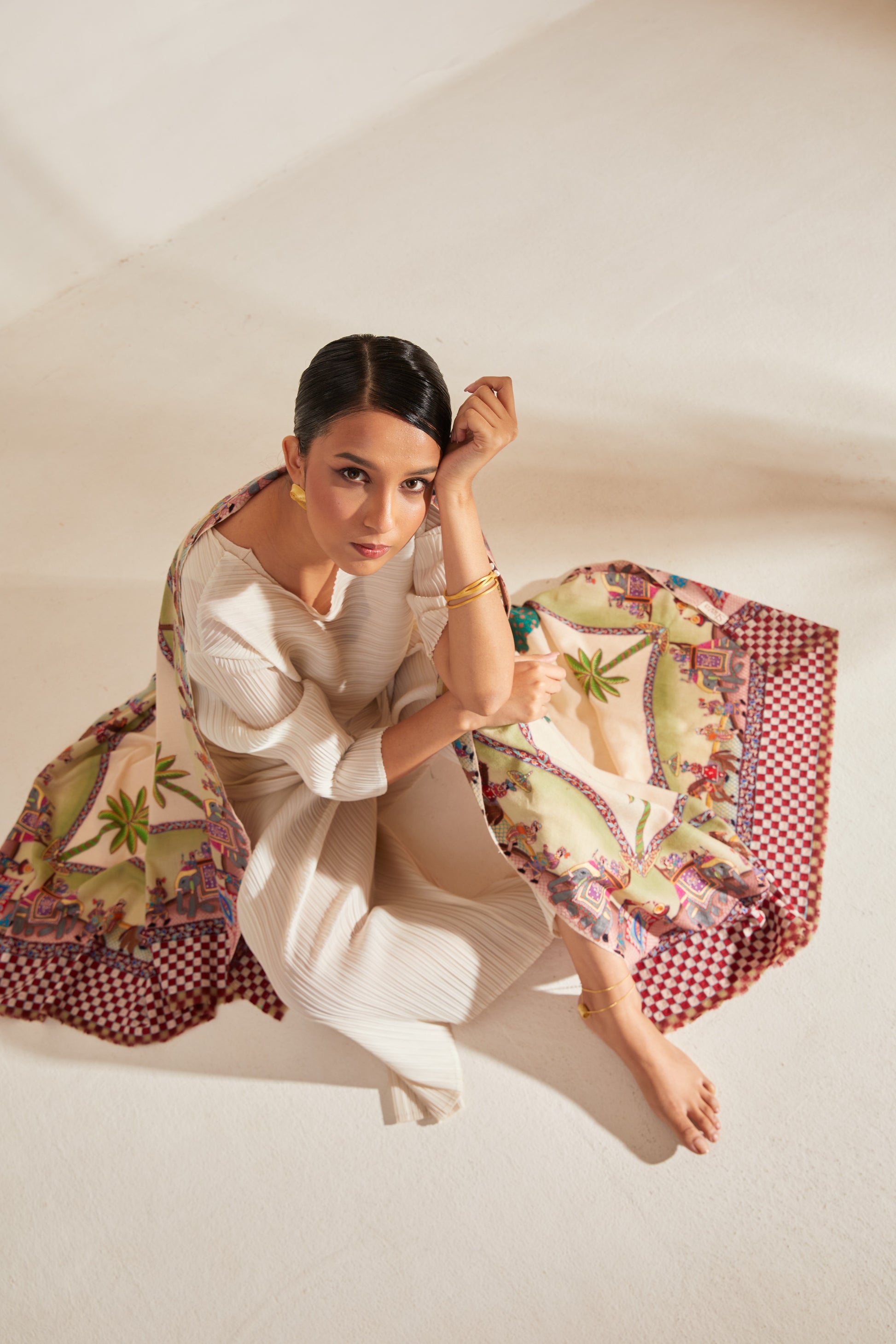 Model is wearing the Var Yatra Pashmina Kalamkari Shawl from Shaza, depicting a baraat procession as the border on a handloomed pashmina.