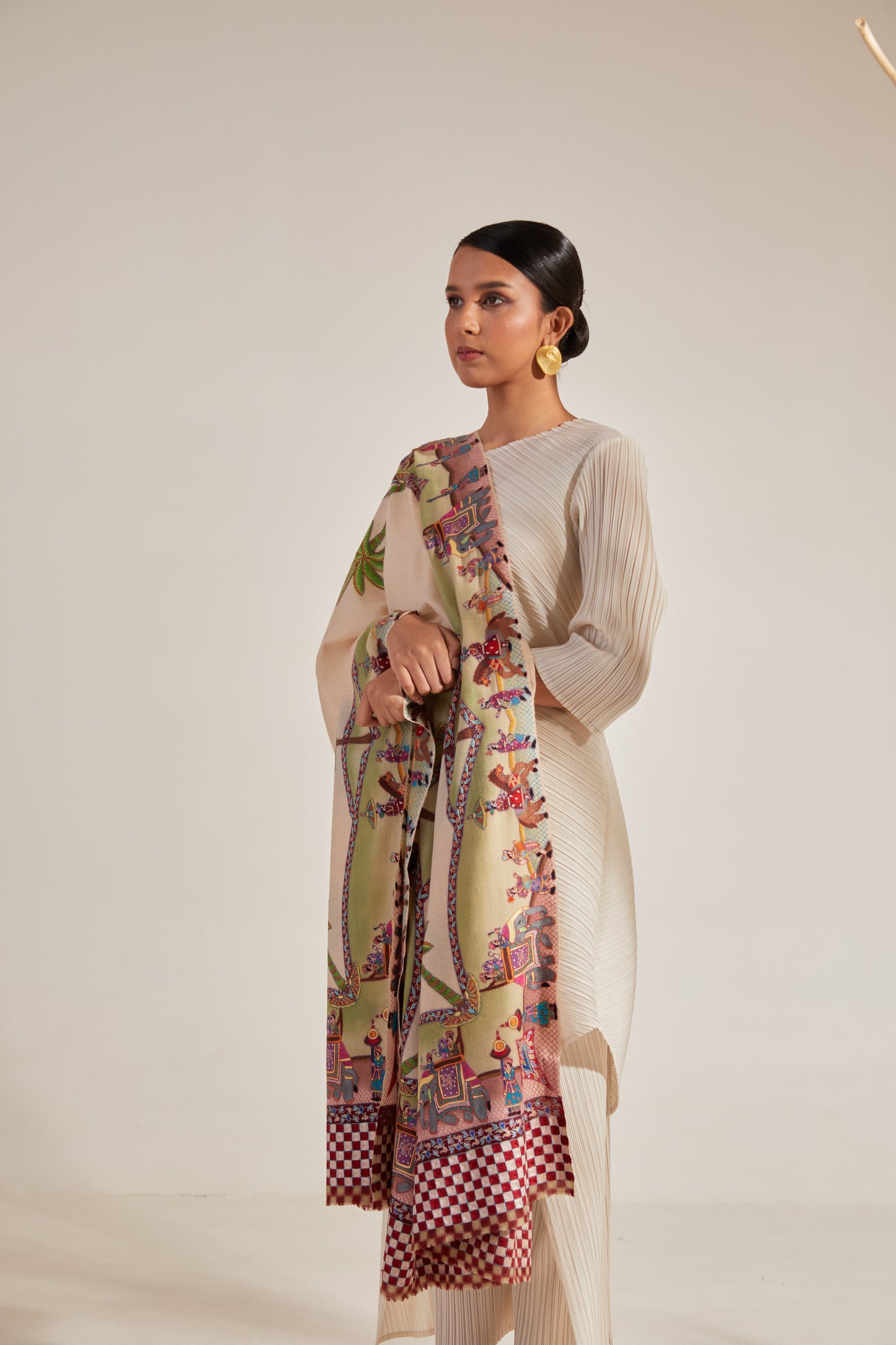 Model is wearing the Var Yatra Pashmina Kalamkari Shawl from Shaza, depicting a baraat procession as the border on a handloomed pashmina.