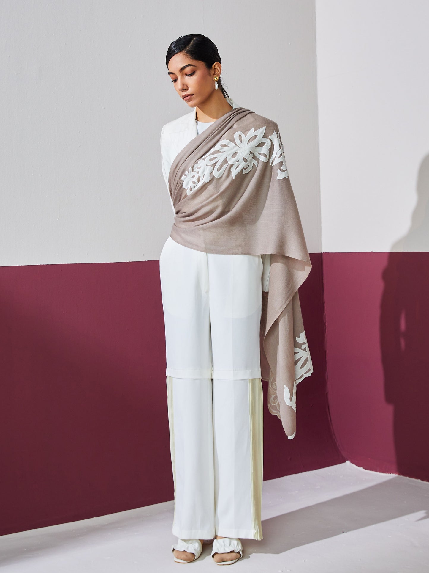 Model is wearing a brown Velvel affair cashmere stole with white applique from Shaza.