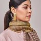 Model is wearing an Ekkat reversible stole in cedar brown from Shaza.