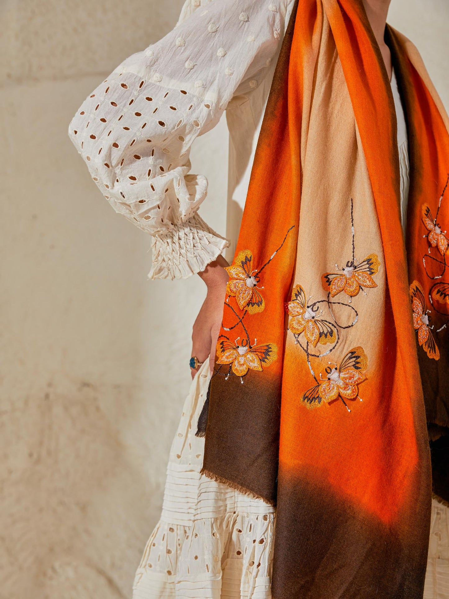 Model is wearing a Beetle pashmina stole from Shaza in the colour Earth, featuring threadwork beetle shapes uplifted with hand embroidered pearls, sequins and swarovski.