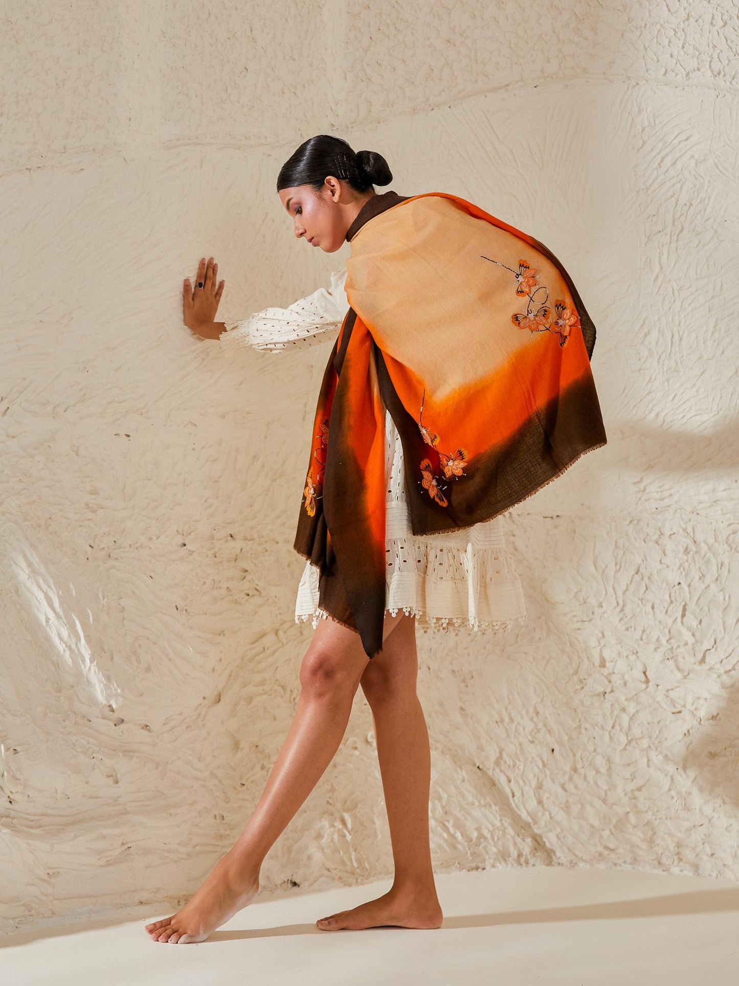 Model is wearing a Beetle pashmina stole from Shaza in the colour Earth, featuring threadwork beetle shapes uplifted with hand embroidered pearls, sequins and swarovski.