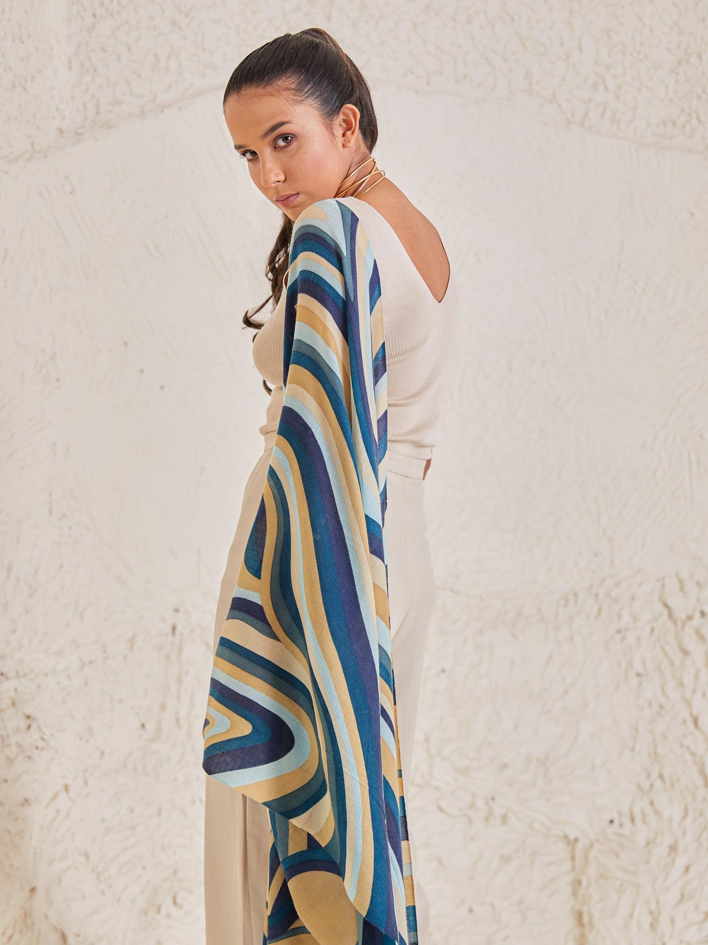 Model is wearing the disruption pashmina stole from shaza, handpainted in colours symbolizing ocean.