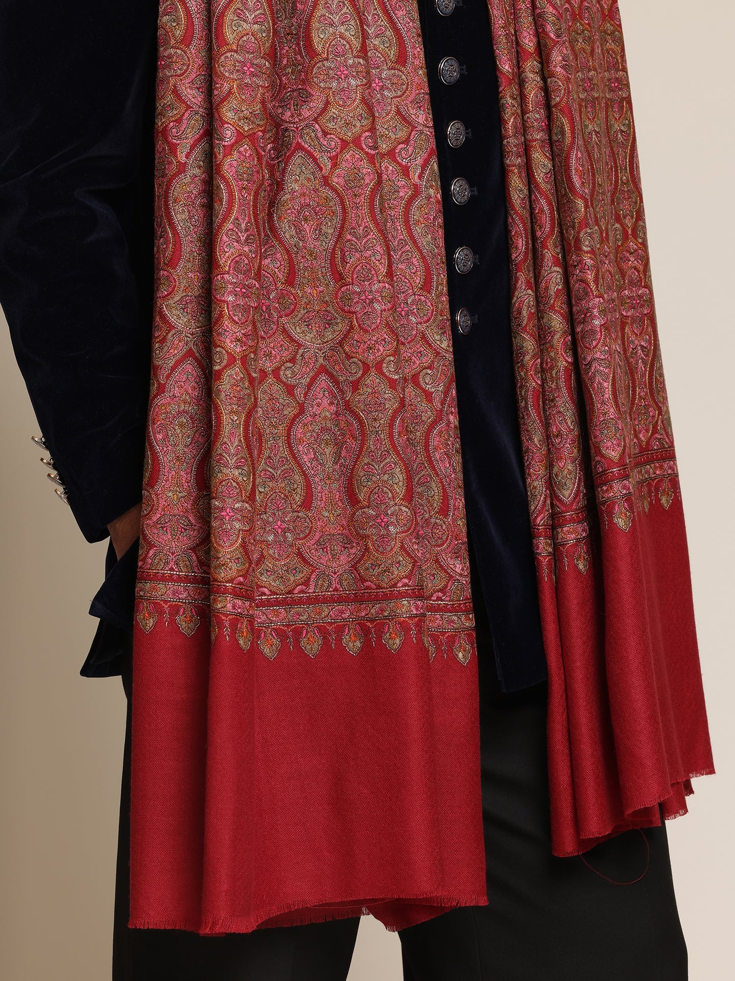 Man wearing a red patterned kalamkari shawl