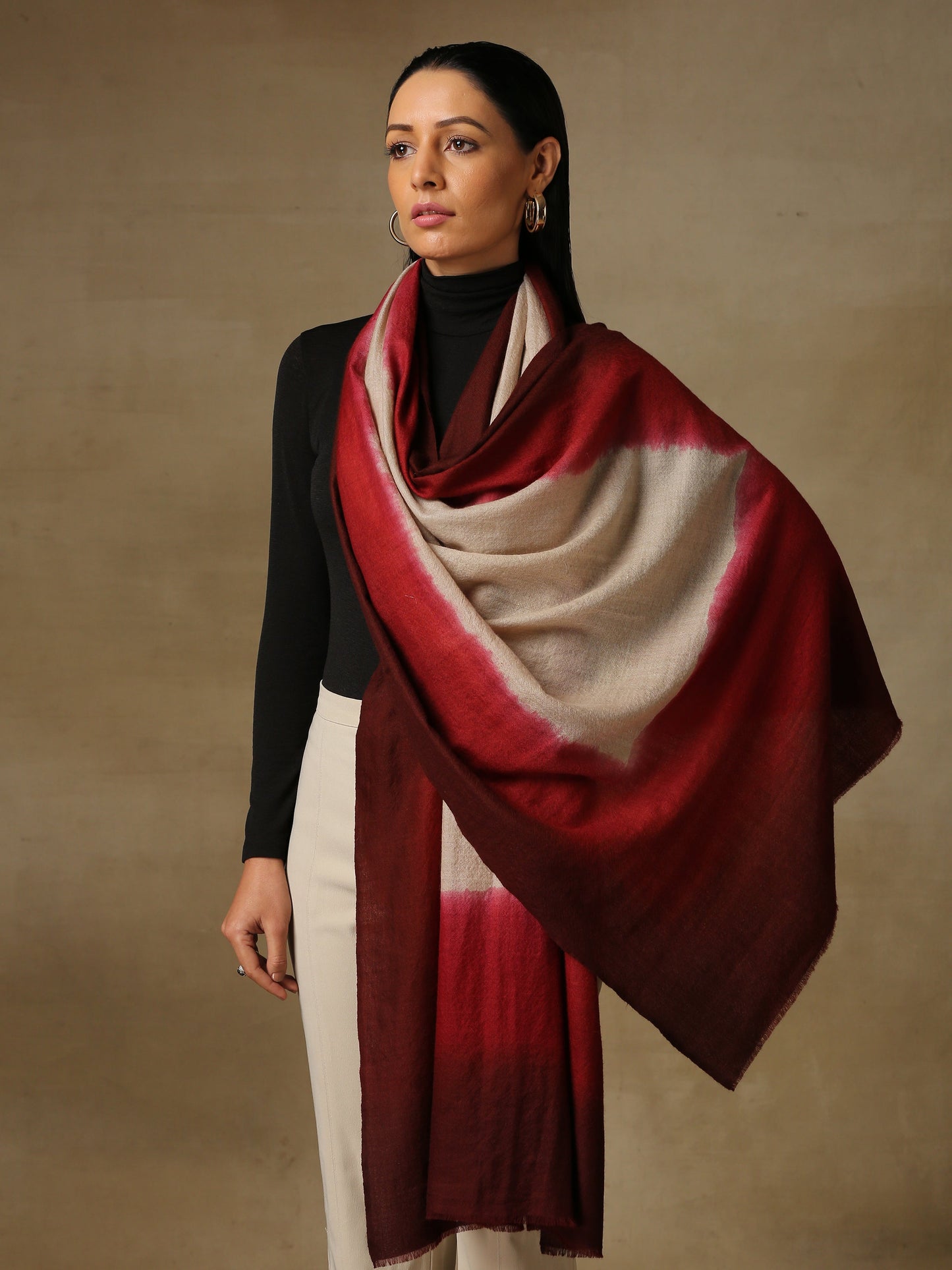 Model is wearing a Saya Ombre stole from Shaza, in the colour blood moon : White, red and maroon.