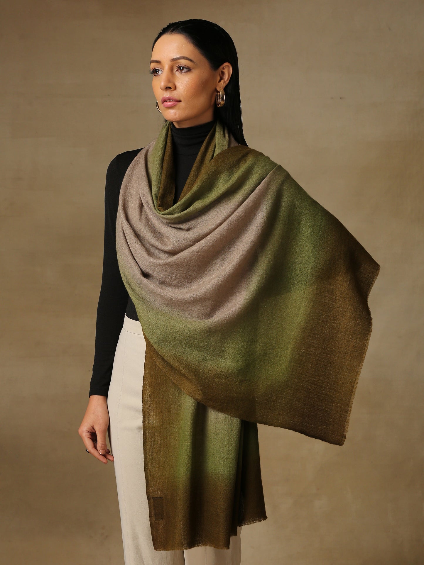 Model is wearing a Saya Ombre stole from Shaza, in the colour Canopy: Toosh, green and brown.
