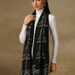 Model is wearing a Vineyard stole in the colour black, featuring curvy shaped cutwork and zari detailing.