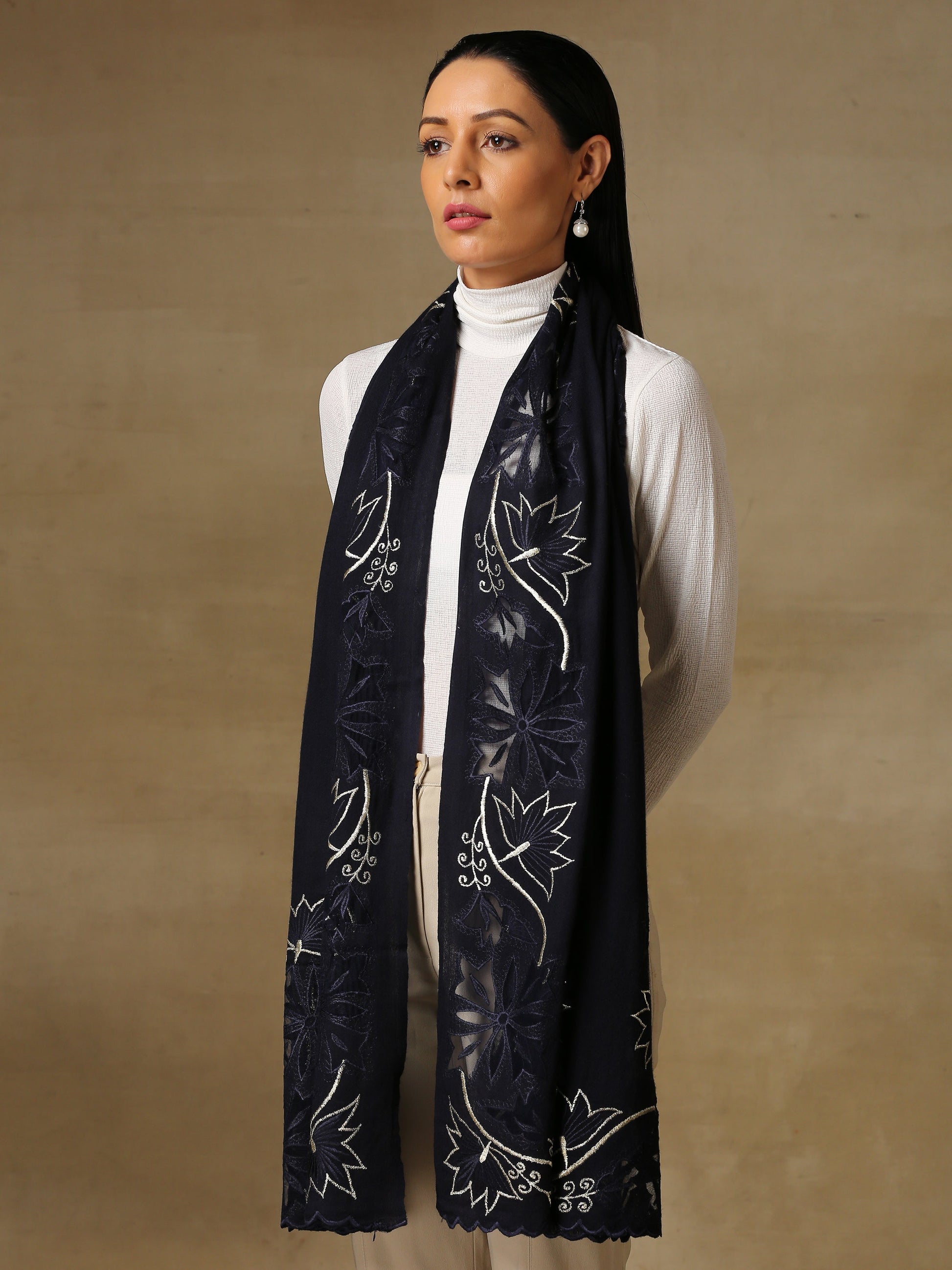 Model is wearing a Vineyard stole in the colour midnight blue, featuring vine shaped cutwork and zari detailing.