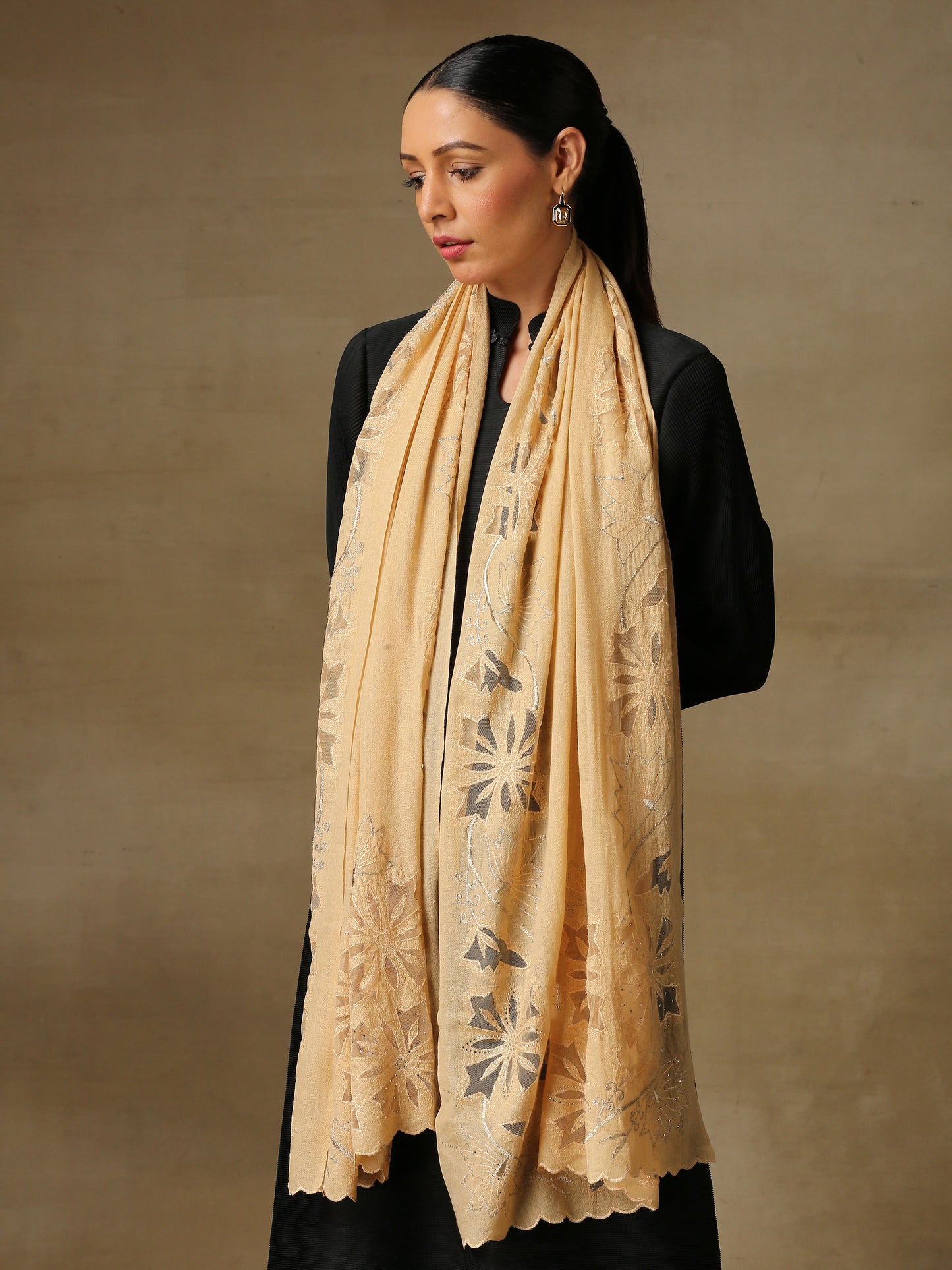 Model is wearing a Vineyard Zaywar stole featuring cutwork vine pattern bordered with zari details and hand embellished with fine swarovski, in a light yellowcolour.
