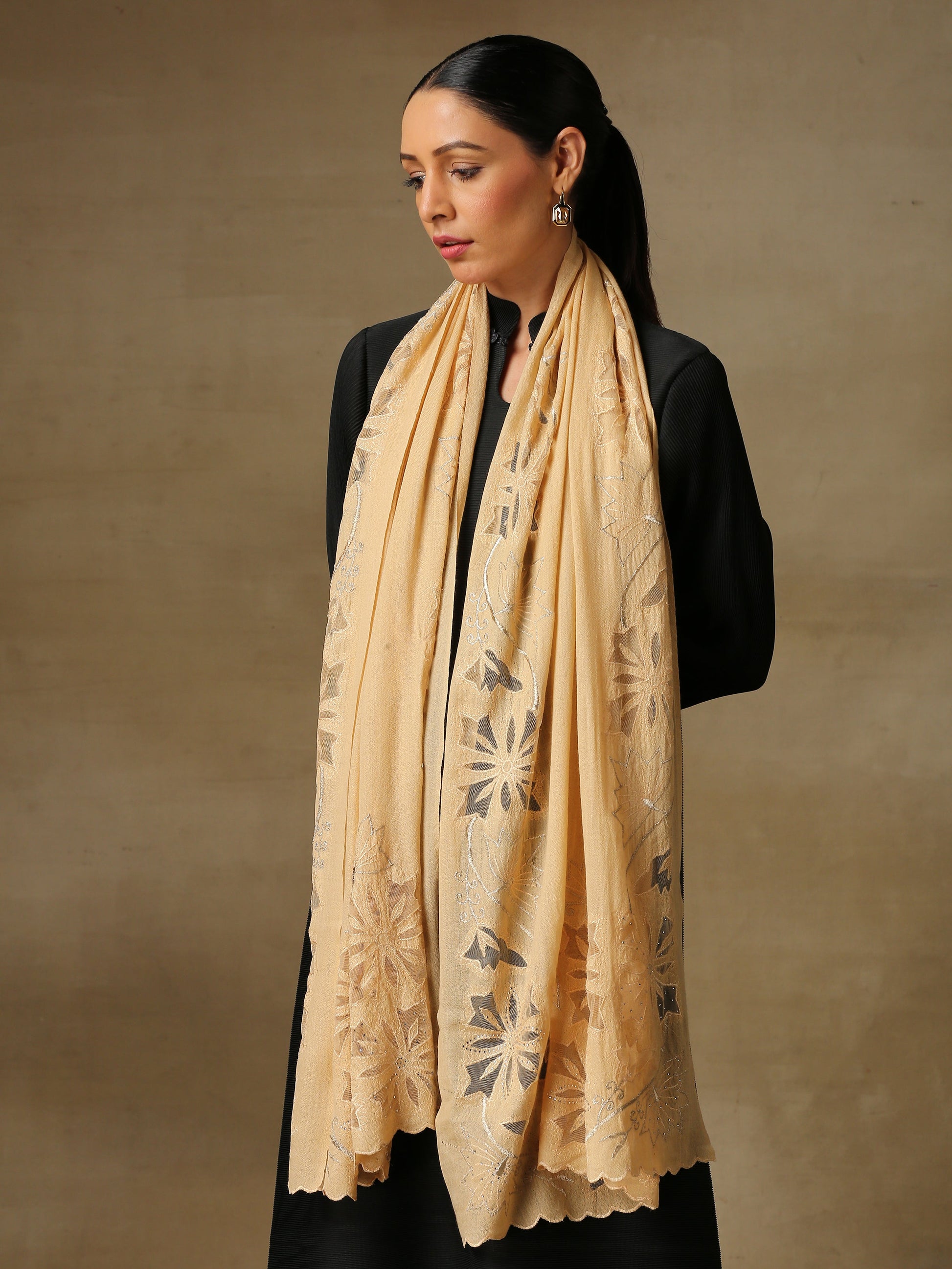 Model is wearing a Vineyard Zaywar stole featuring cutwork vine pattern bordered with zari details and hand embellished with fine swarovski, in a light yellowcolour.