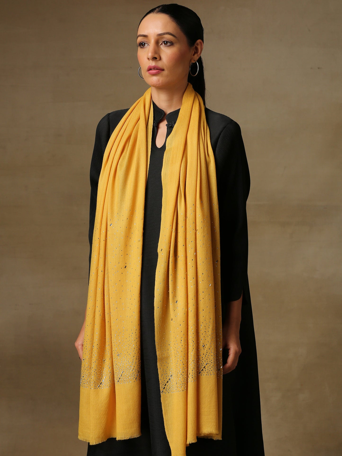 Model is wearing a swarovksi studded Era of Zaywar Palla Stole in the colour yellow. .