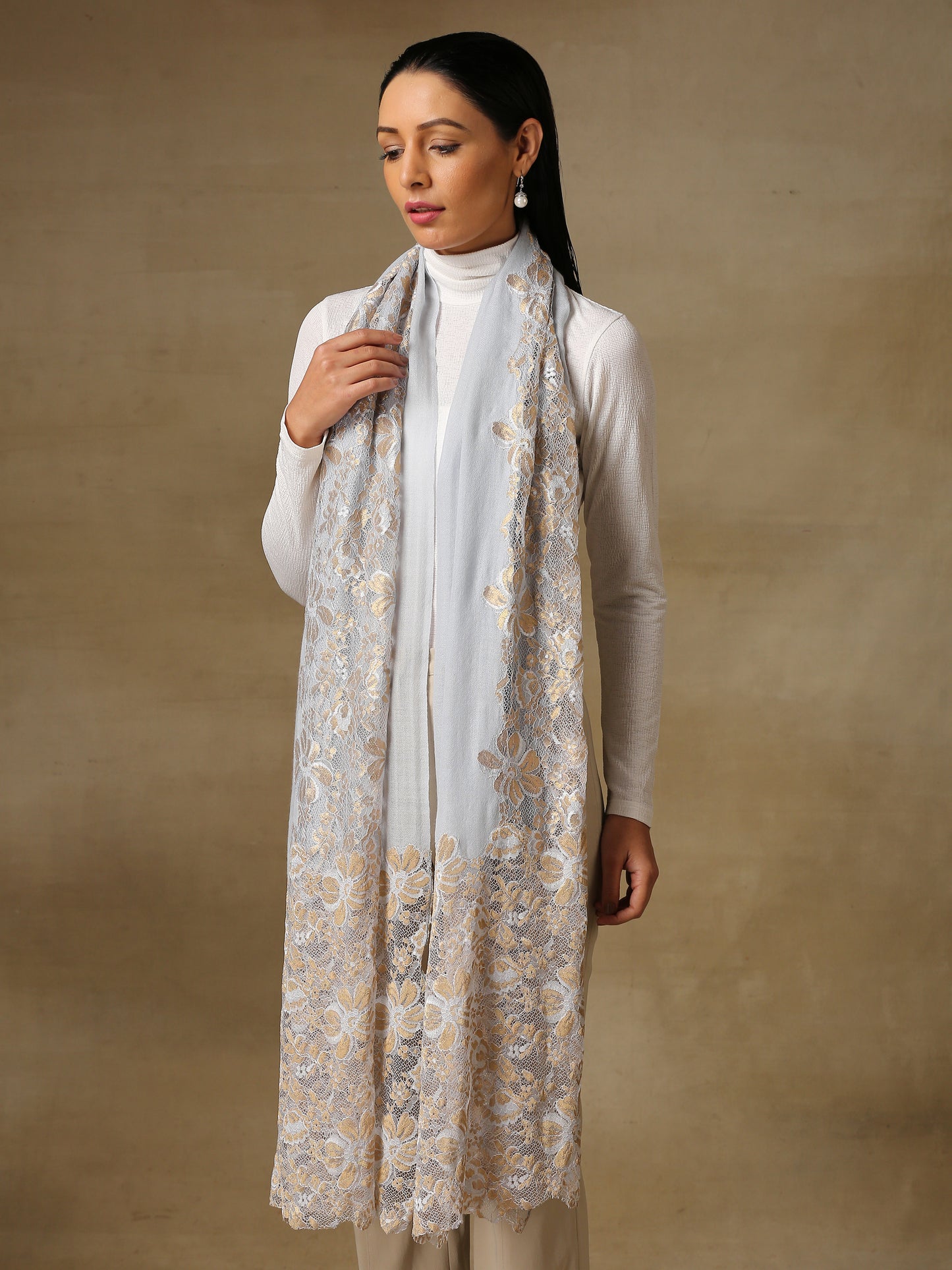 Model is wearing Celestial Chantilly stole from Shaza in ice blue.