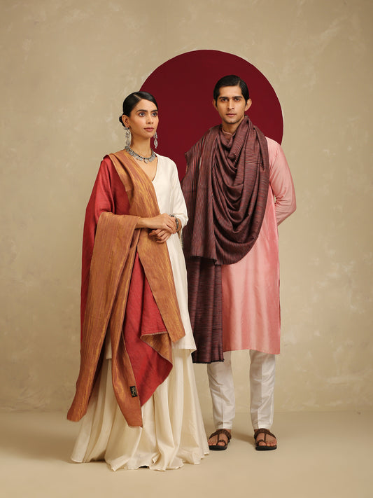 Model is wearing pashmina reversible shawl in red with gold at the back.