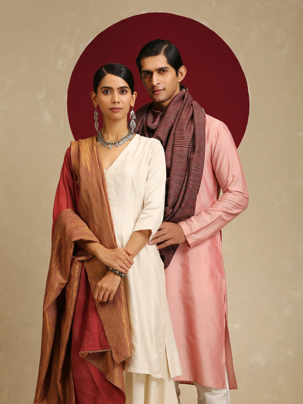 Model is wearing pashmina reversible shawl in red with gold at the back.