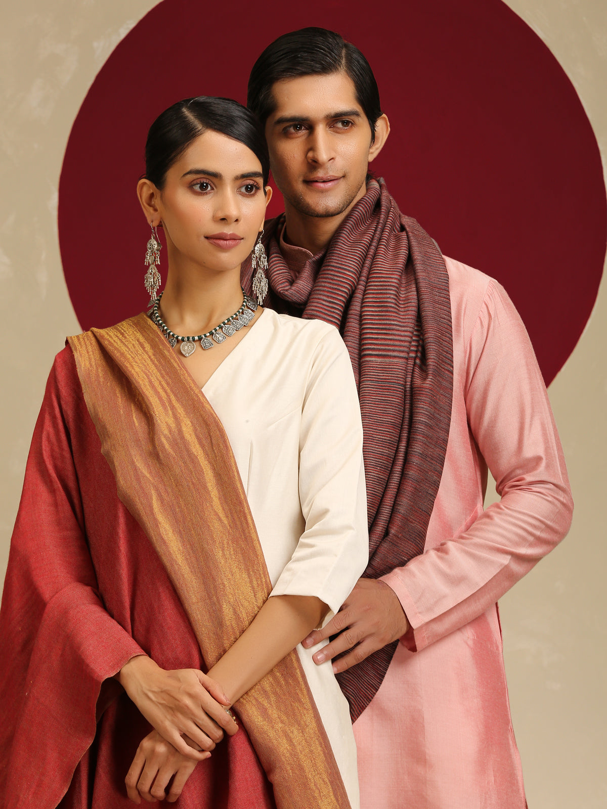 Model is wearing pashmina reversible shawl in red with gold at the back.