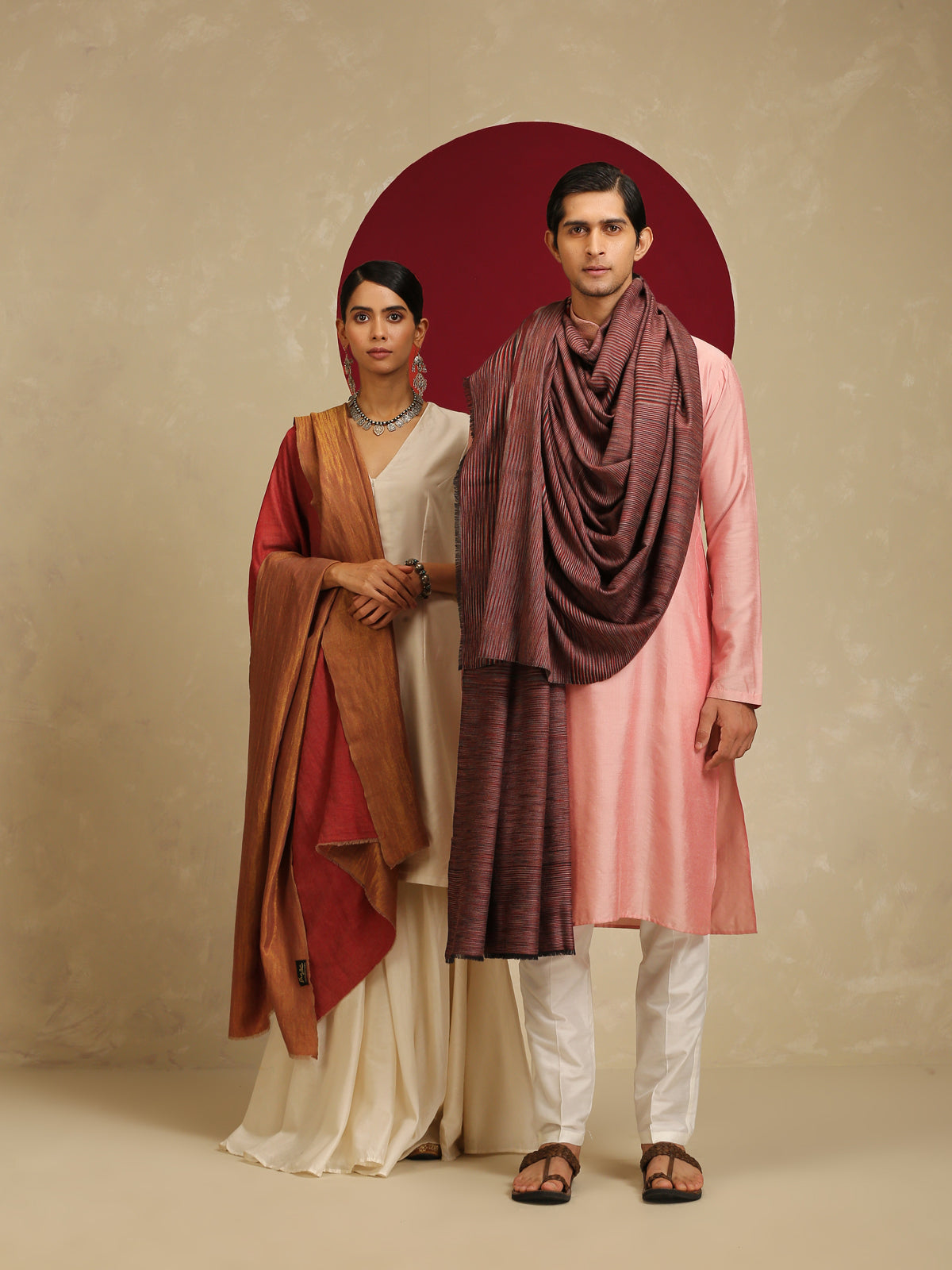 Model is wearing pashmina reversible shawl in red with gold at the back.