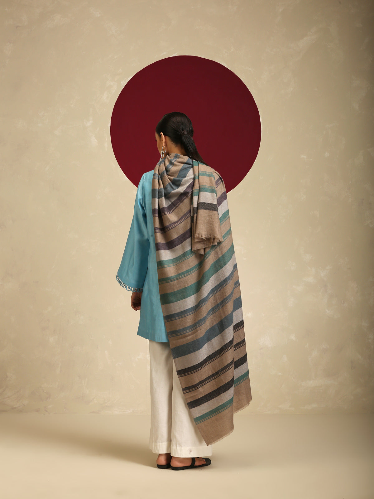 Model is wearing a Pashmina check stole in green and purple stripes.