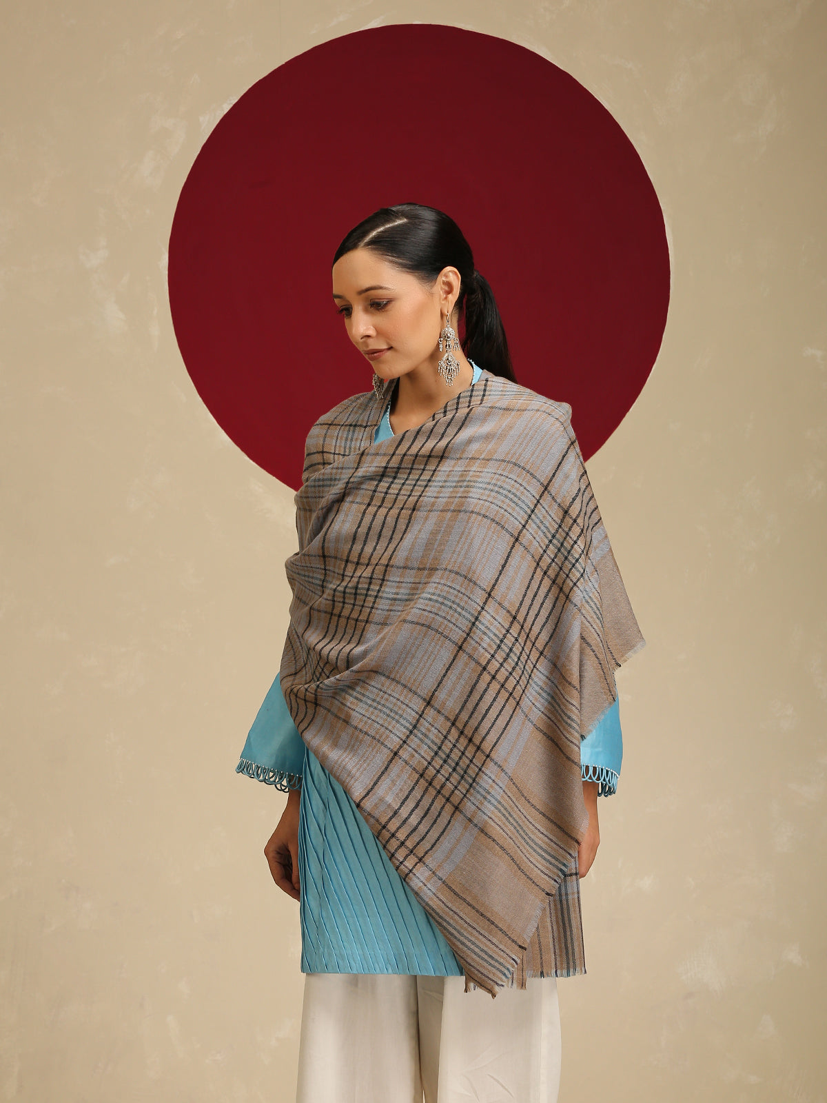 Model is wearing a Pashmina Check stole from Shaza with black and blue cross lines on a toosh coloured base.