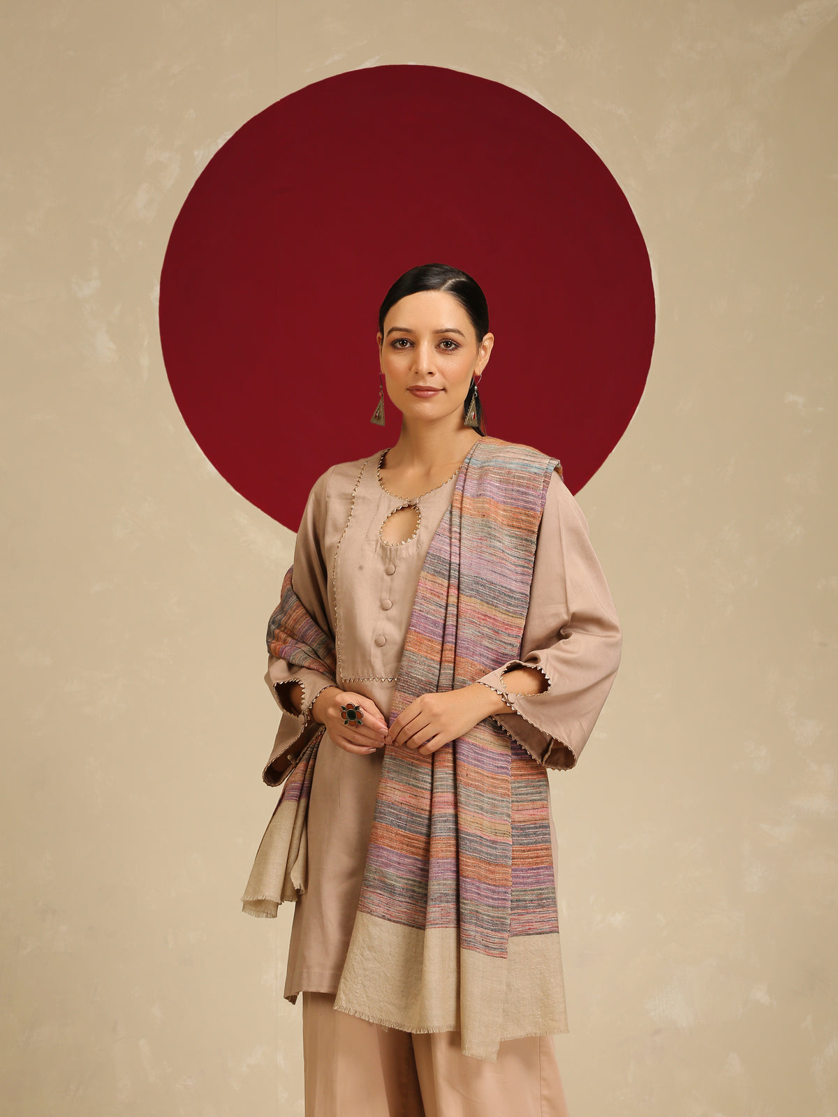 Model is wearing a Pashmina Stripe Stole featuring multicolour stripes on a light gray base.
