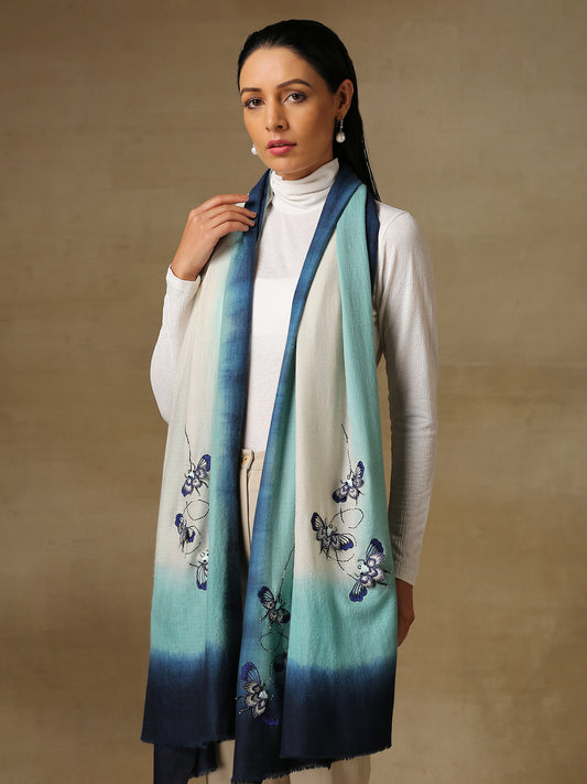 Model is wearing a Beetle pashmina stole from Shaza in the colour Ocean, featuring threadwork beetle shapes uplifted with hand embroidered pearls, sequins and swarovski..