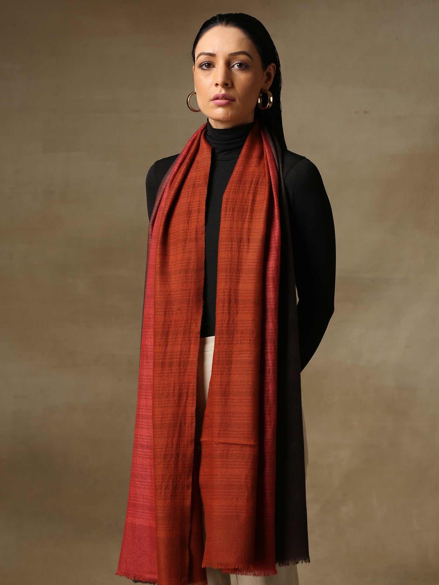 Model is wearing a Pashmina Ombre stole in Self weave in the colours charcoal black and red.