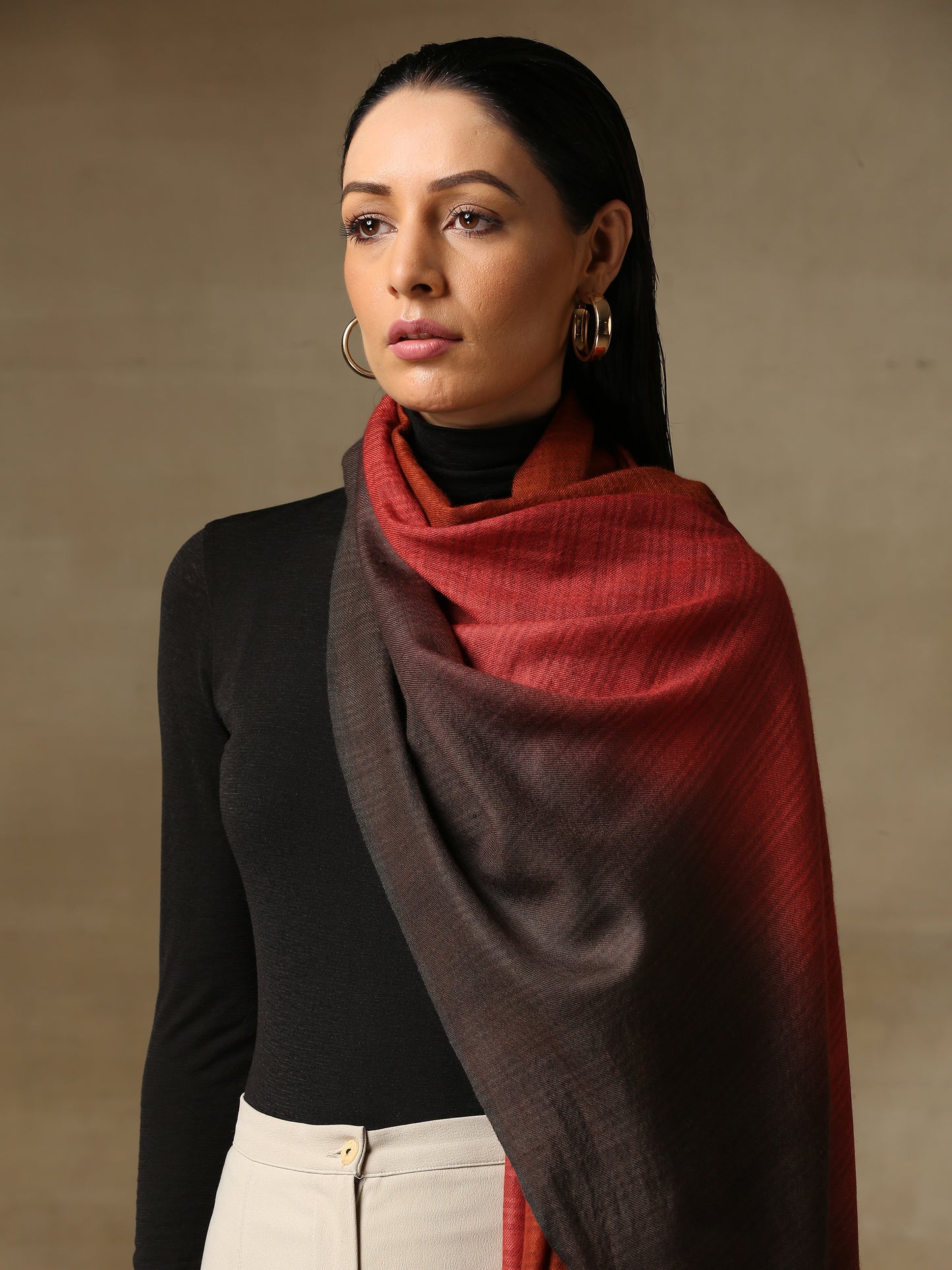 Model is wearing a Pashmina Ombre stole in Self weave in the colours charcoal black and red.