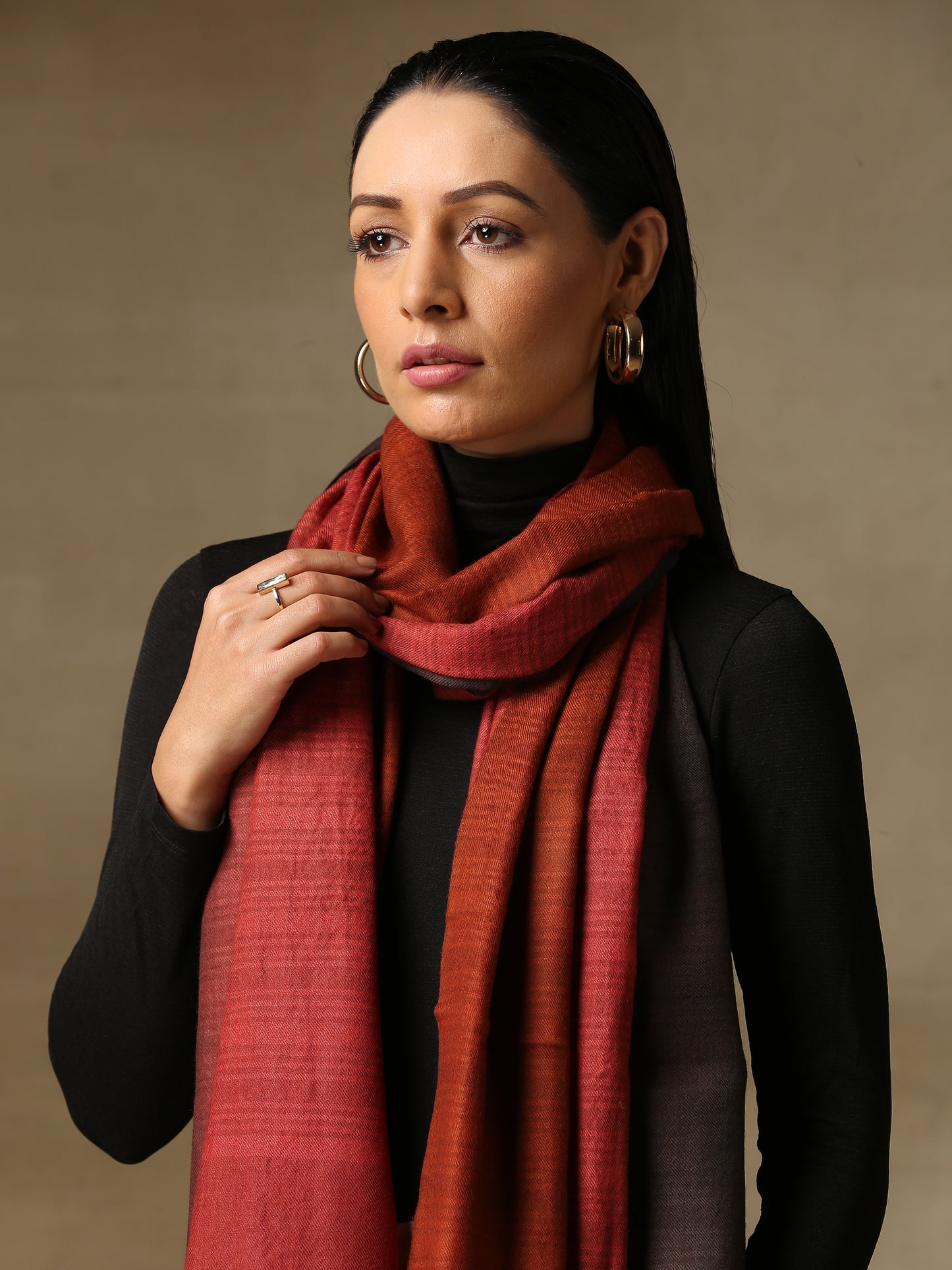 Model is wearing a Pashmina Ombre stole in Self weave in the colours charcoal black and red.