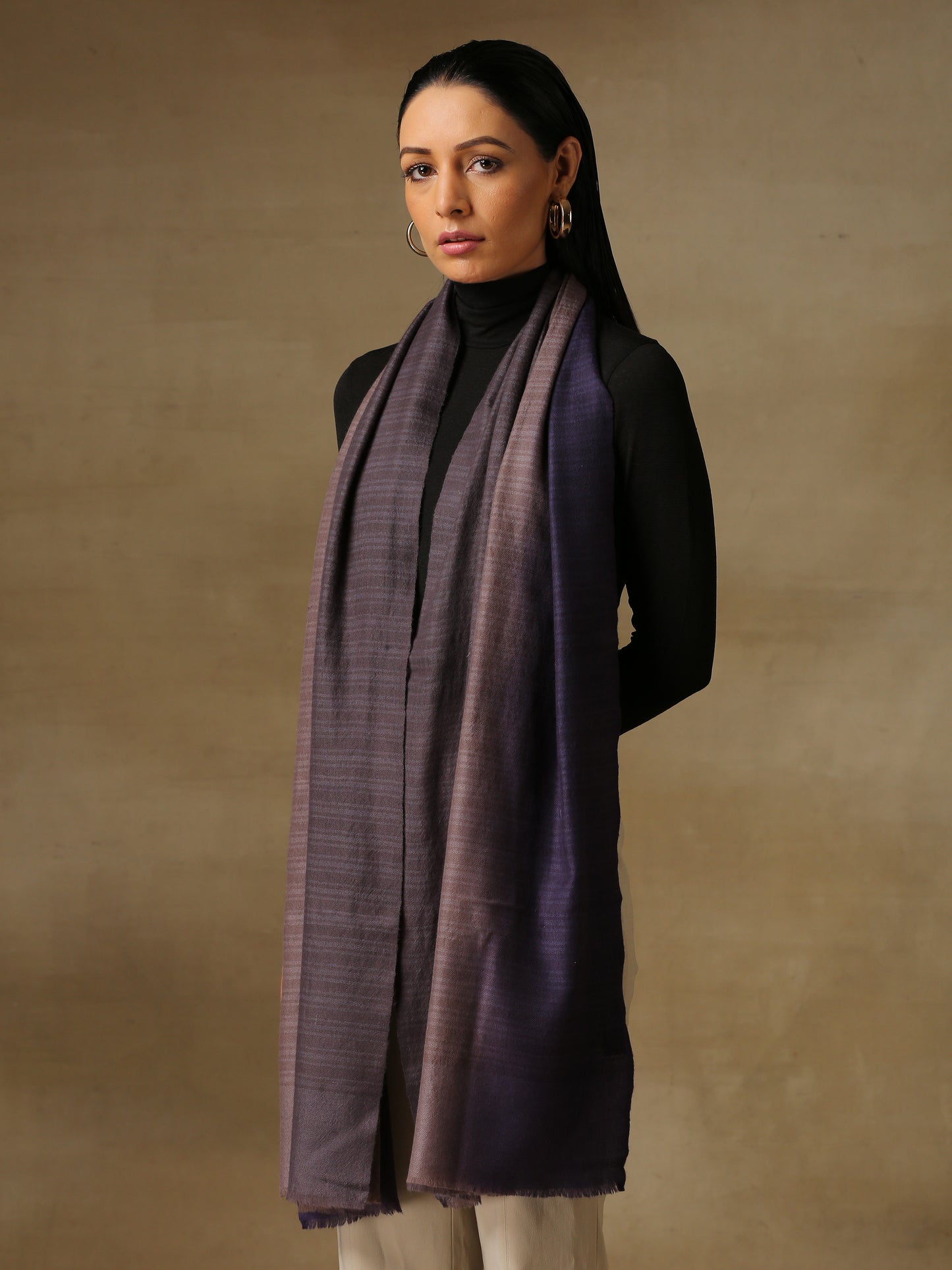 Model is wearing pashmina ombre in self weave stole in cedar colours of gray and violet.