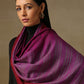 Model is wearing a Pashmina Ombre stole in Self weave in the colours violet and red. 