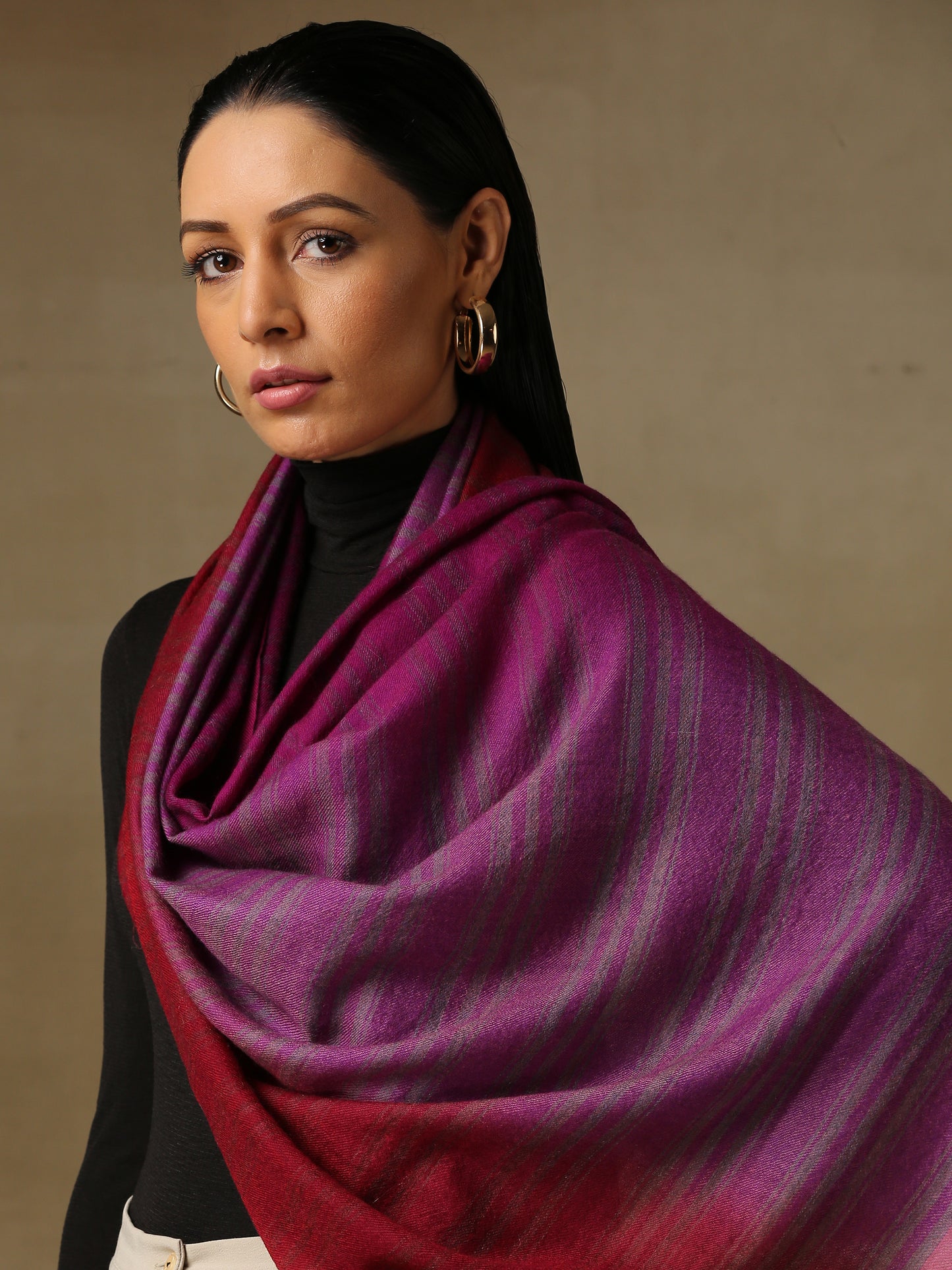 Model is wearing a Pashmina Ombre stole in Self weave in the colours violet and red.