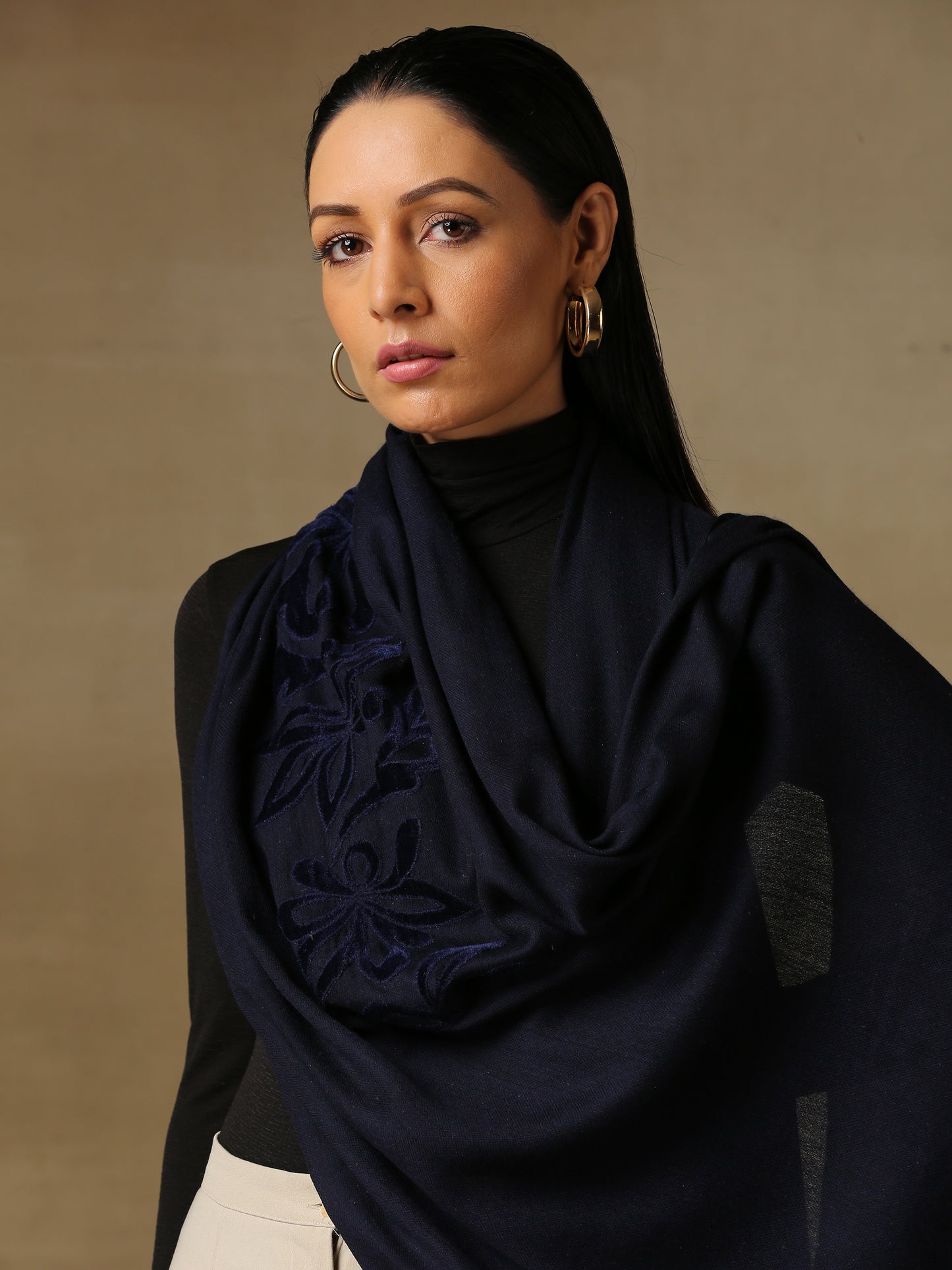 Model is wearing a Velvet Affair stole from Shaza featuring navy blue velvet applique on a navy blue coloured cashmere stole.
