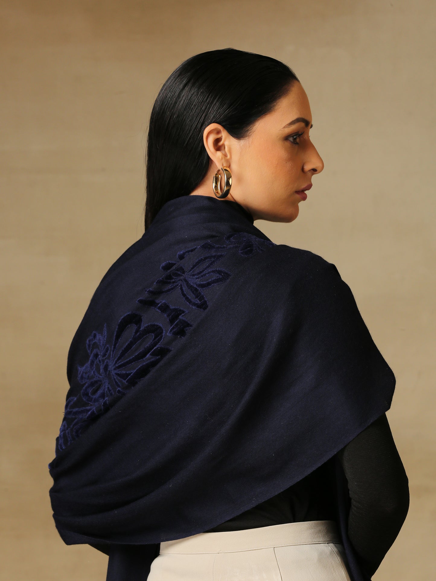 Model is wearing a Velvet Affair stole from Shaza featuring navy blue velvet applique on a navy blue coloured cashmere stole.