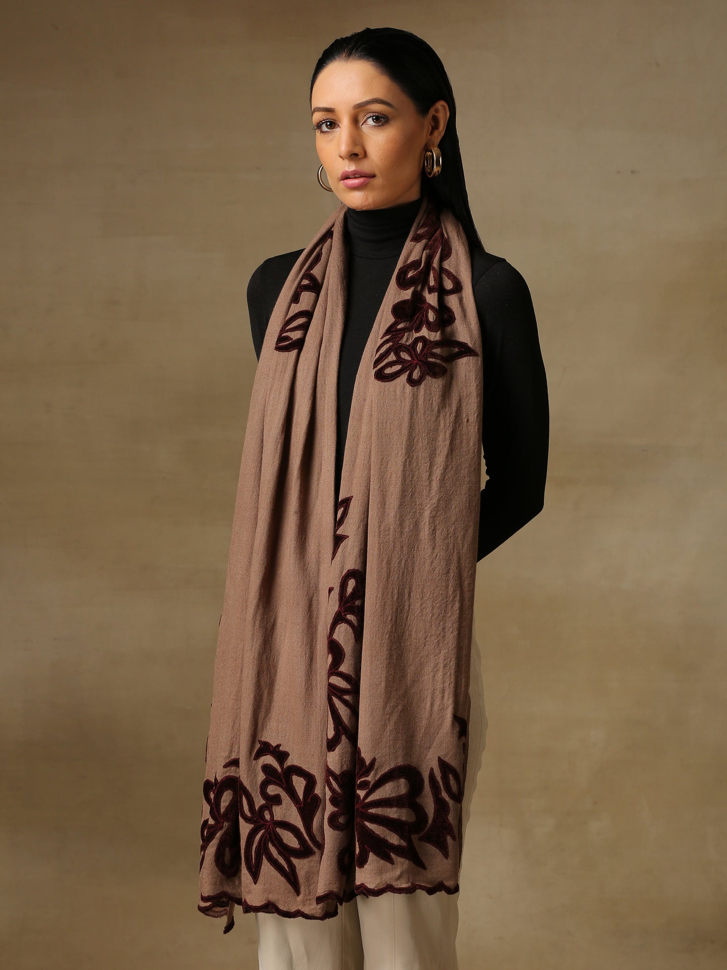 Model is wearing a Velvet Affair stole from Shaza featuring brown velvet applique on a toosh coloured cashmere stole.