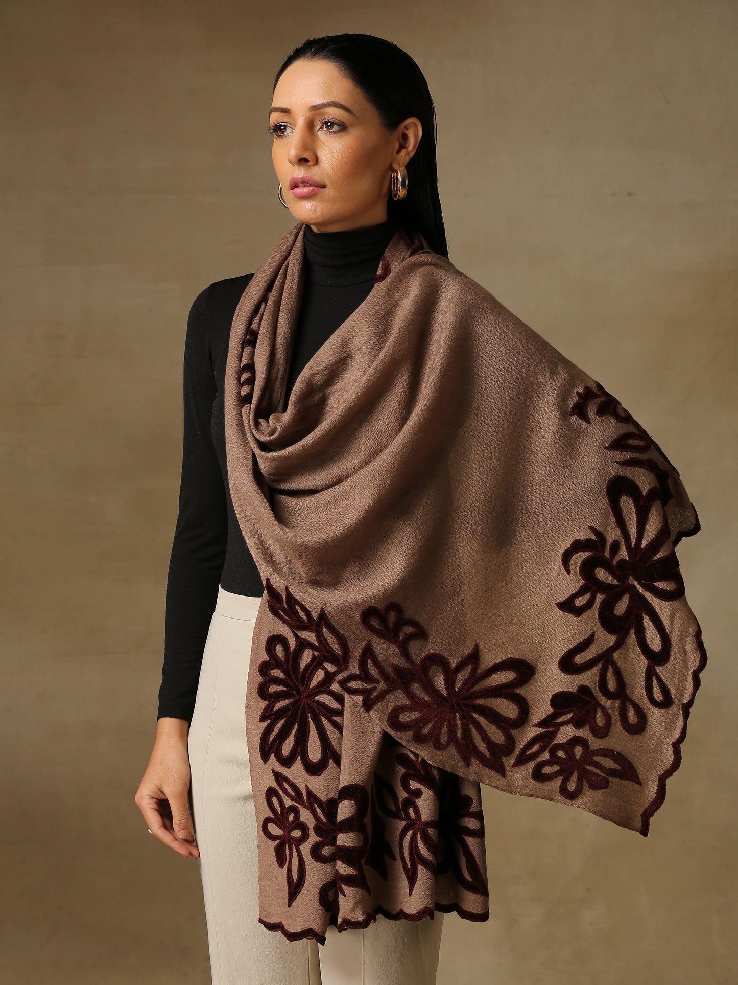 Model is wearing a Velvet Affair stole from Shaza featuring brown velvet applique on a toosh coloured cashmere stole.