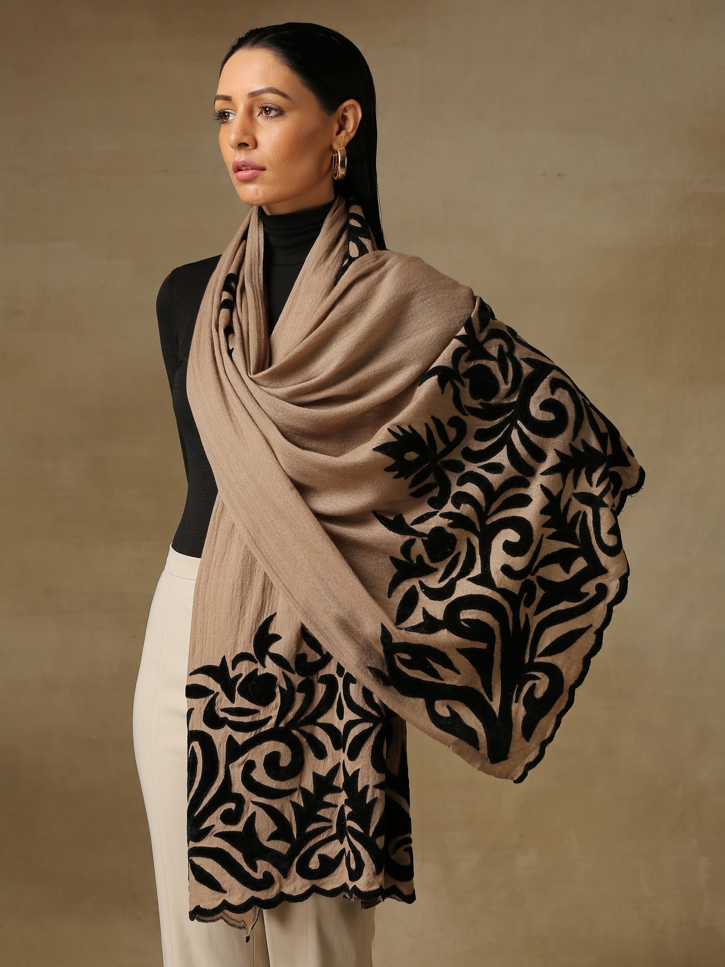 Model is wearing a Velvet Affair stole from Shaza featuring black velvet applique on a toosh coloured cashmere stole.