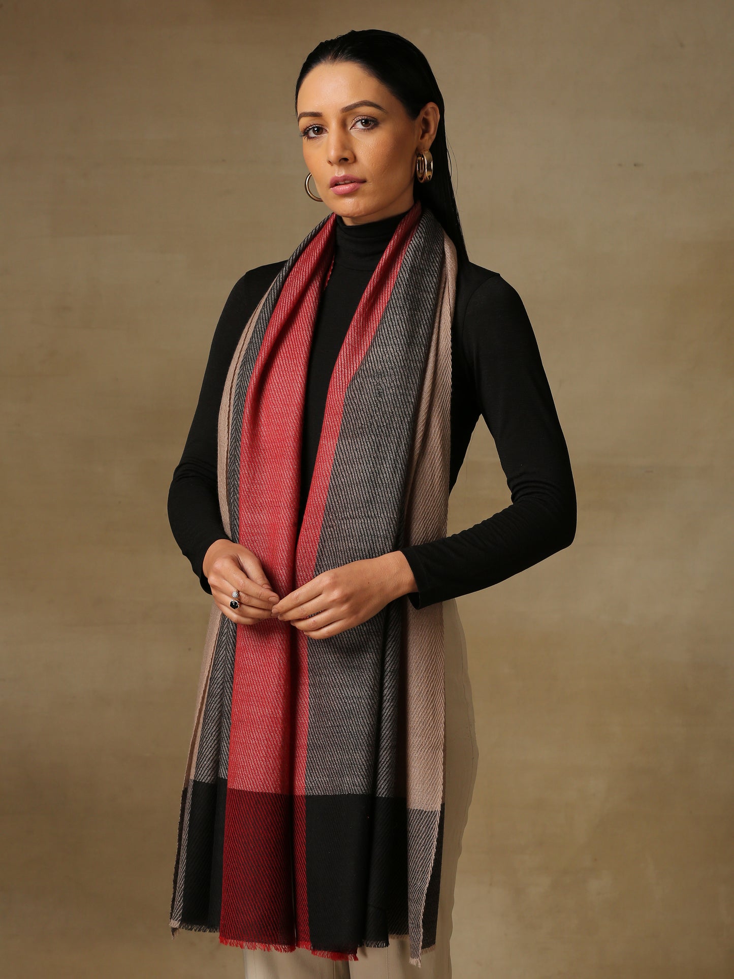 Model is wearing a Pardah stole by Shaza in red and black