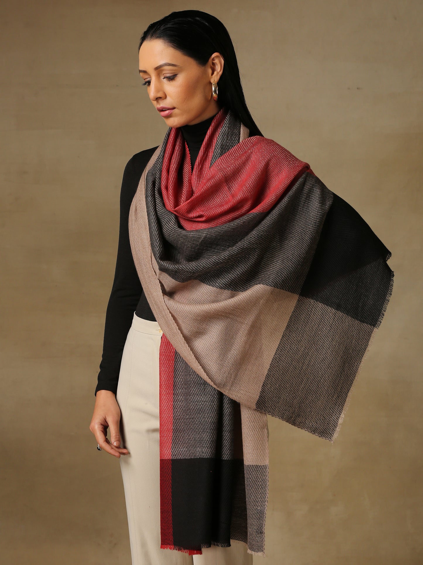 Model is wearing a Pardah stole by Shaza in red and black