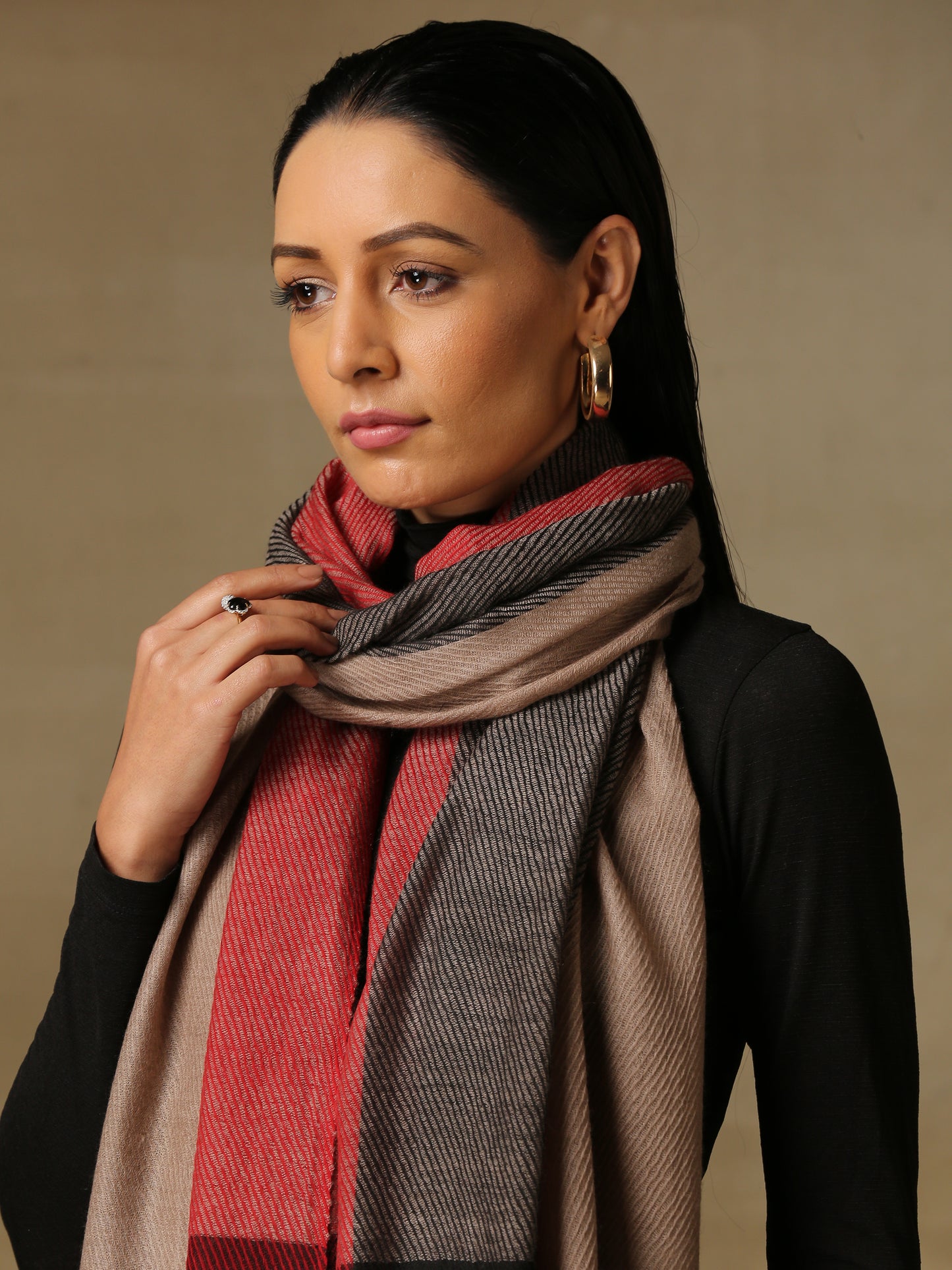 Model is wearing a Pardah stole by Shaza in red and black