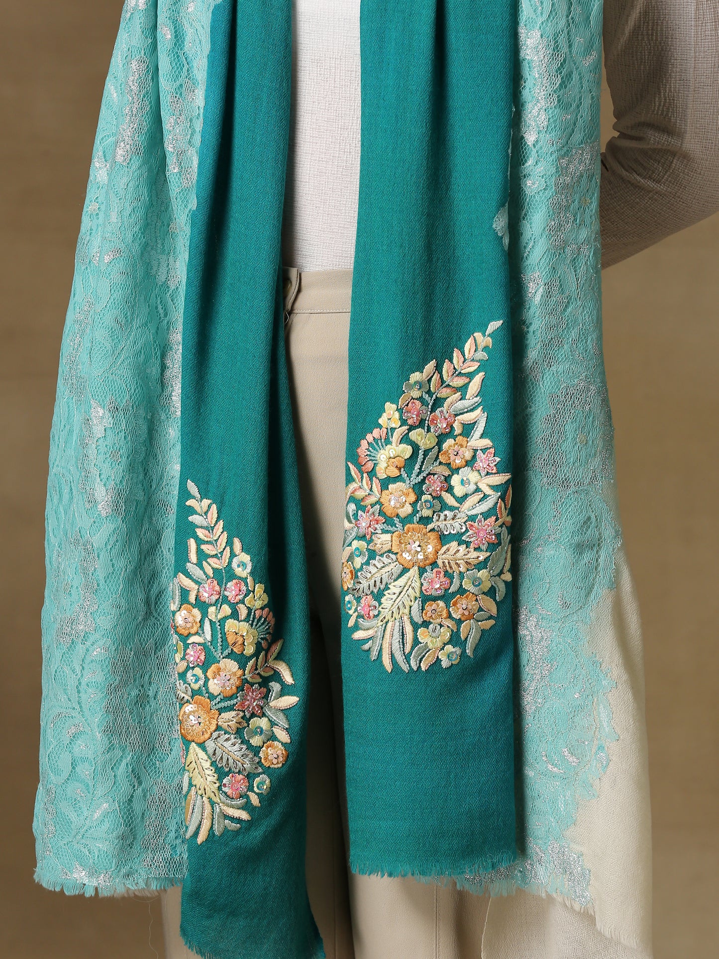 Model is wearing Enchanted pashmina stole from shaza in the colour coral reefs featuring a hand painted ombre in blue and white colours and delicate threadwork embroidery consisting of pearls, shellwork and cutdana.