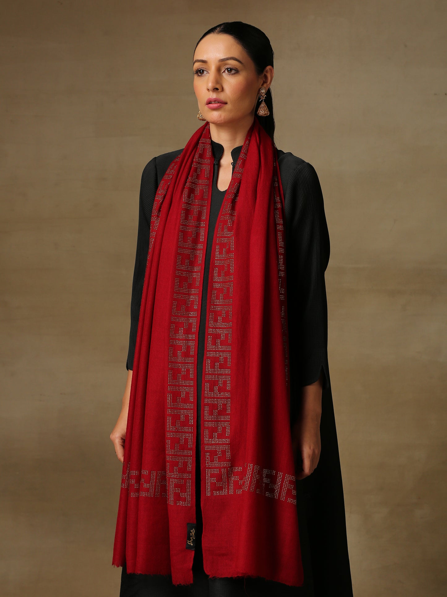 Model is wering a maroon coloured stole from the Era of Zaywar Border Swarovski Stole collection, hand embellished with gold swarovski in an abstract design.