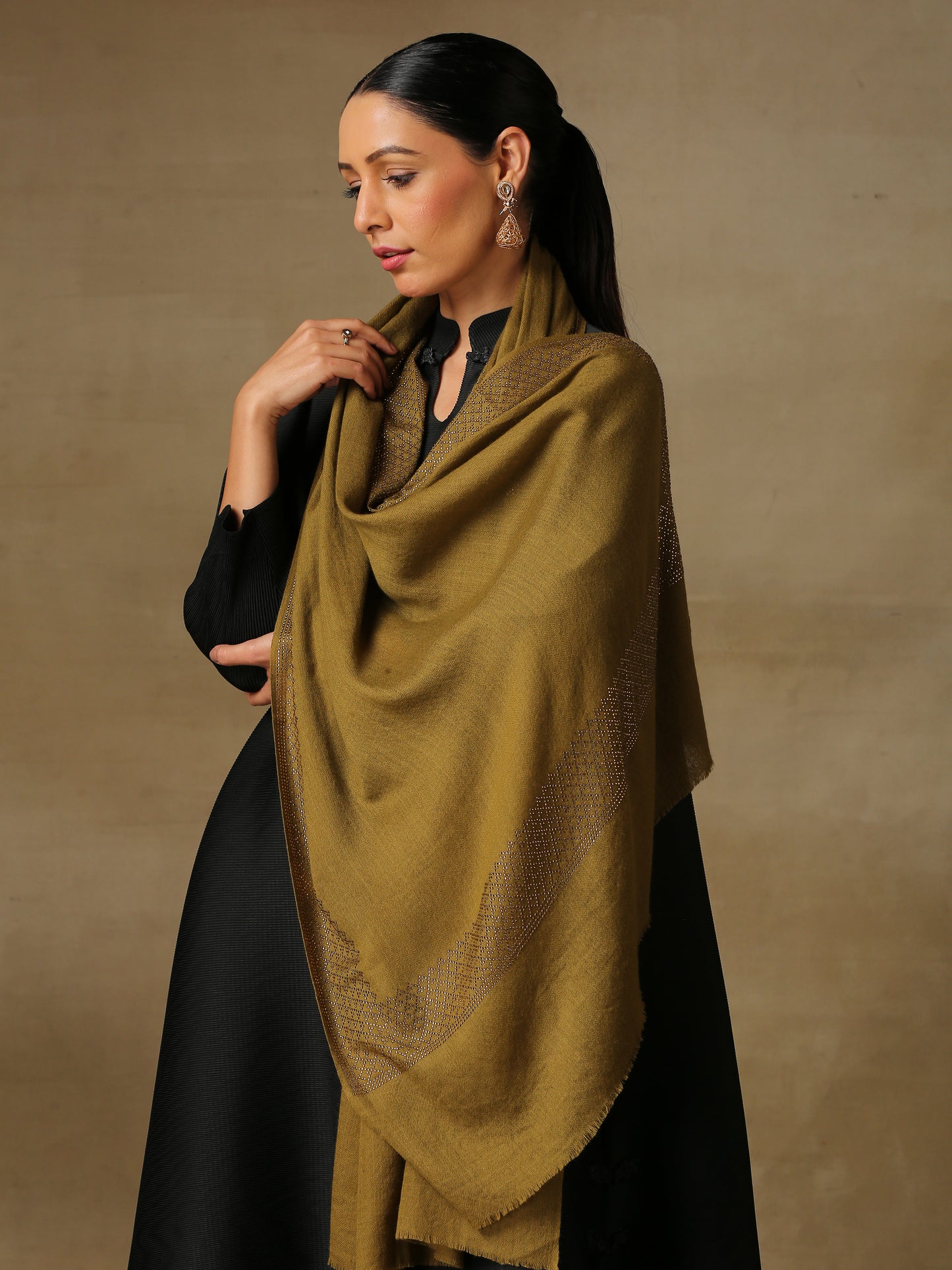 Model is wearing a henna coloured stole from the Era of Zaywar Border Swarovski Stole collection, hand embellished with gold swarovski in a cubes design.
