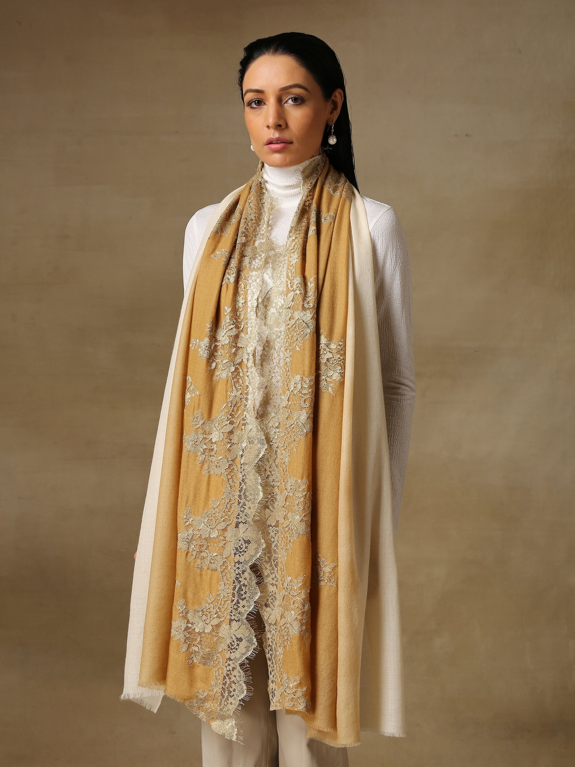 Model is wearing a Pashmina celestial chantilly stole in the colour desert.. 