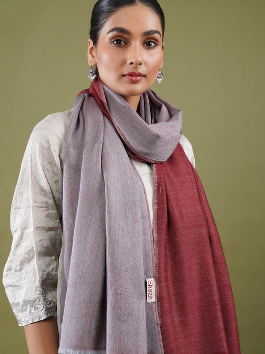 Woman wearing a gray and red stole.