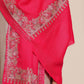 Woman wearing a bright pink woolen stole