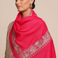 Woman wearing a bright pink woolen stole