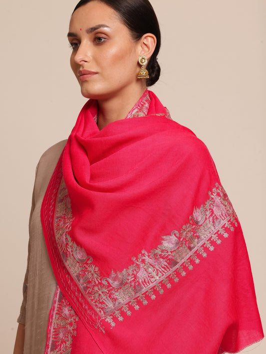 Woman wearing a bright pink woolen stole