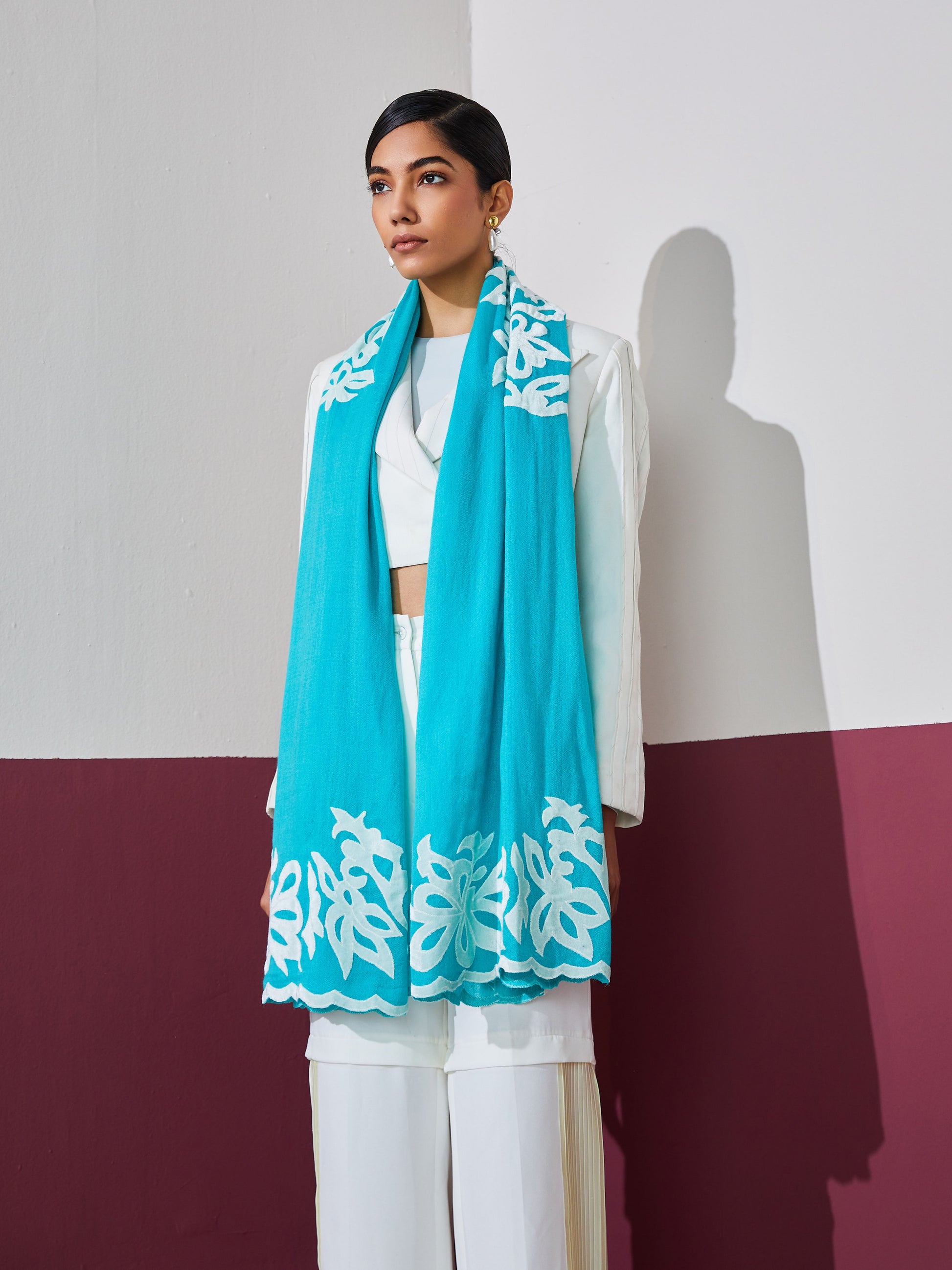 Model is wearing a firozi blue Velvet affair cashmere stole with white applique from Shaza.