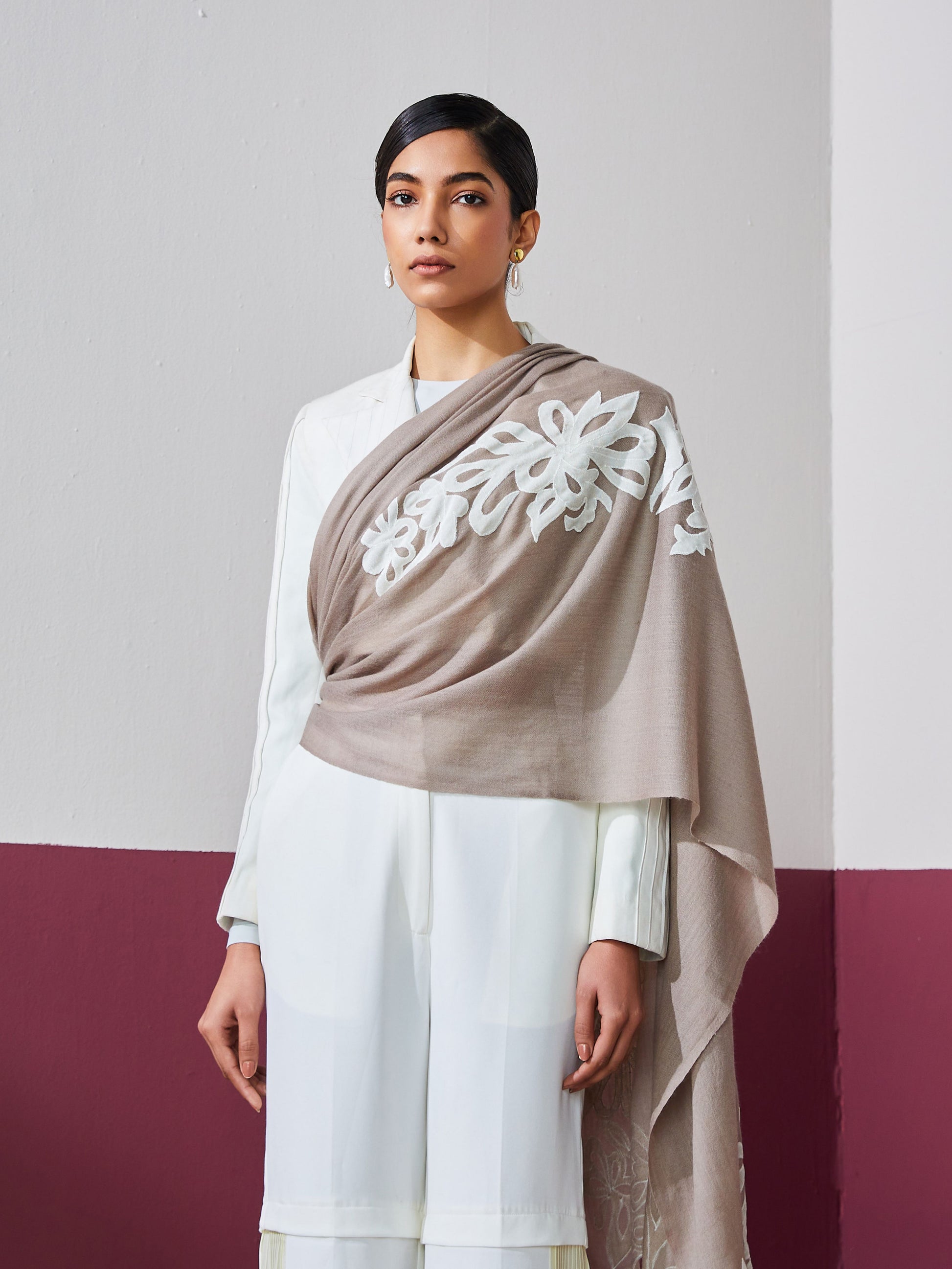 Model is wearing a brown Velvel affair cashmere stole with white applique from Shaza.